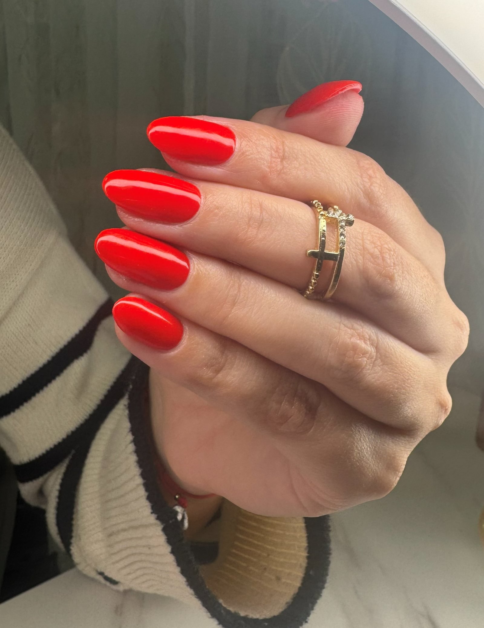 Bright red gel manicure on almond nails, done at Guapa! Nail Studio in Coral Gables